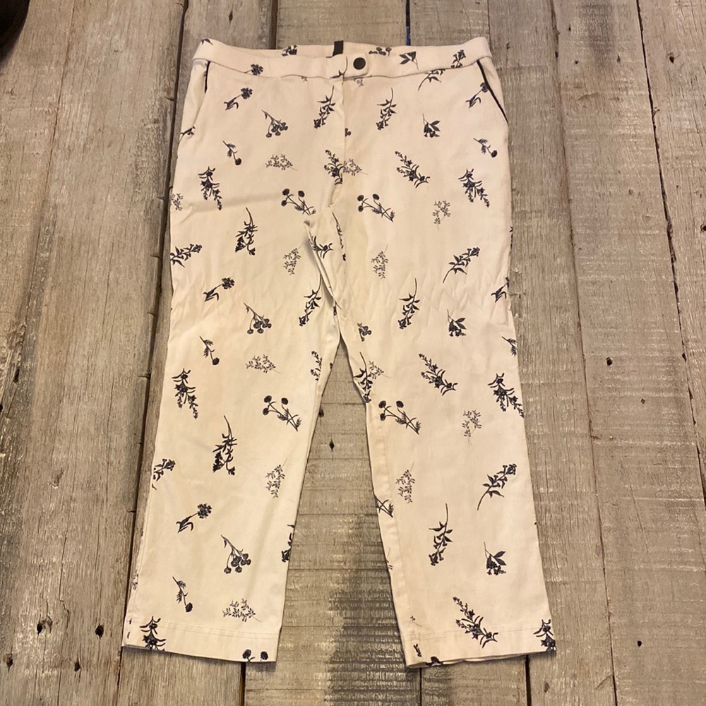 White pants with floral print in blue with navy accents.